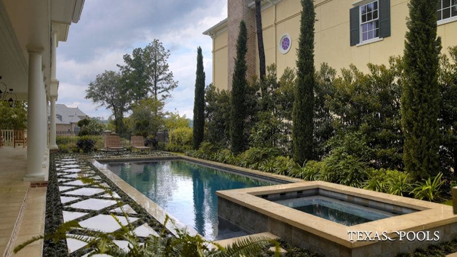 Custom pool with raised spa and tiled water feature