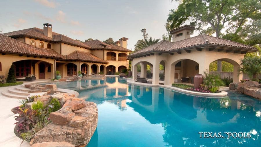 Geometric pool with sun shelf and covered outdoor living area